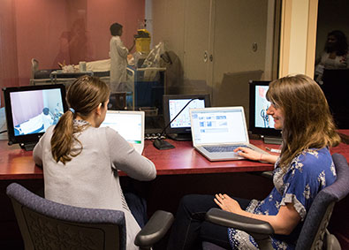 Two students work at computers