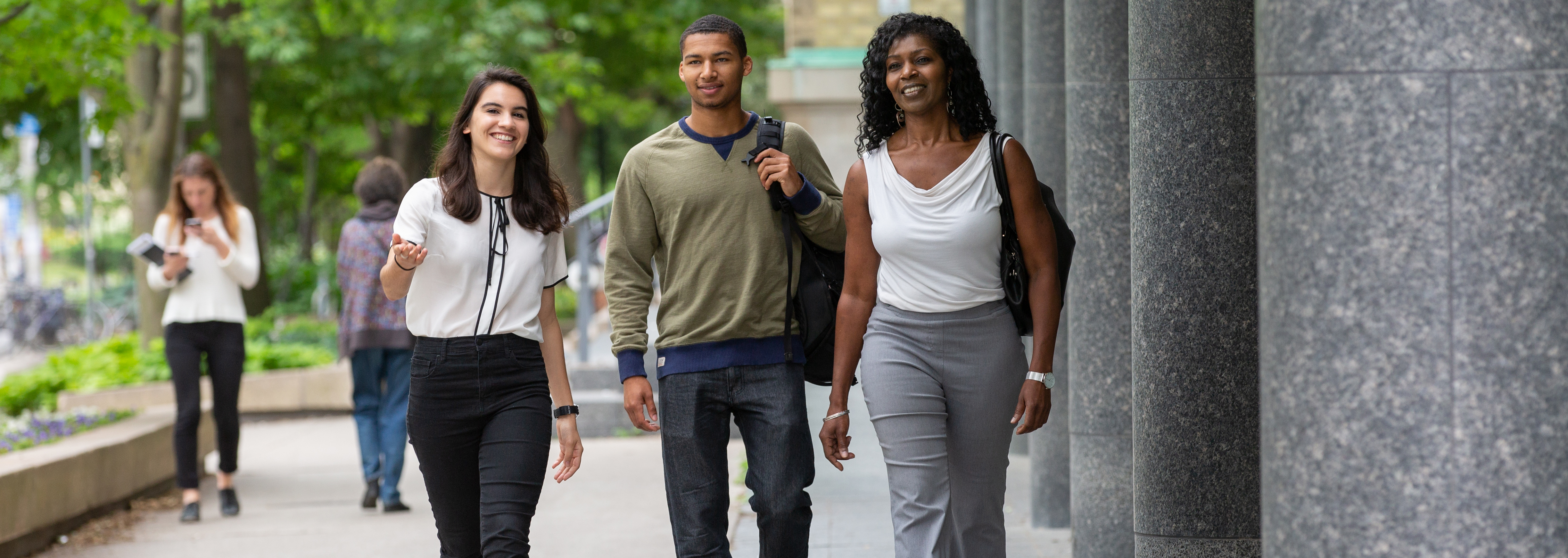 applicant and parent walking with a student tour guide