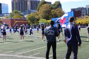 Students carrying a U of T flag in Varsity Stadium.