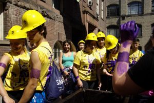 Students wearing hard hats and purple dye