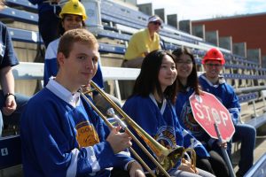 Members of the SKULE band sit in bleachers.