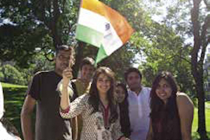 A group of students from the Indian Students Association pose with an Indian flag.